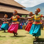 르완다의 민속 춤 페스티벌 개최 - A vibrant traditional Rwandan dance festival scene under bright daylight, featuring a group of dance...